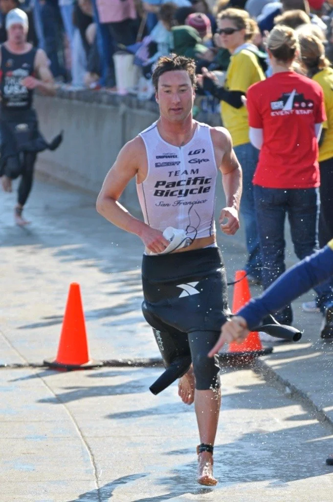 Coach JD running out of the swim during a triathlon